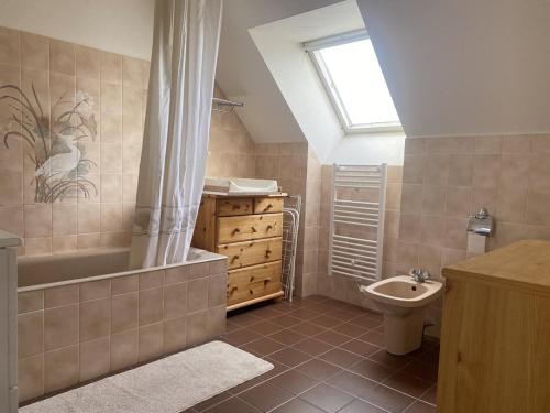uma casa de banho com uma banheira, um WC e um lavatório. em 753 - Belle maison à Erquy à 1km5 des plages et 2km5 du centre em Erquy