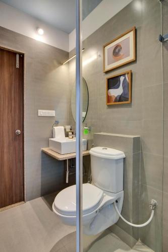 a bathroom with a toilet and a sink at ELIVAAS Shourya Bliss Lux 3BHK Villa with Pvt Pool, Udaipur in Udaipur