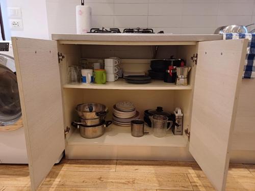 a cupboard filled with dishes and pots and pans at Ca' delle Furlane in Venice