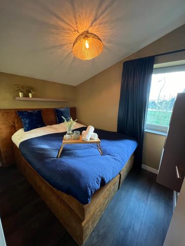 a bedroom with a bed with a table on it at Parc La Dune Marrakesh Lodge in Warmenhuizen