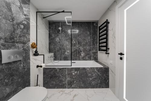 a bathroom with a shower and a toilet at 77 views apartments by INSHI in Lviv