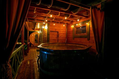 a large wooden room with a large tub in it at Domek całoroczny RYSIÓWKA na Kaszubach z basenem banią sauną bilardem na wyłączność - Ostrowite Leśna Dolina in Sulęczyno