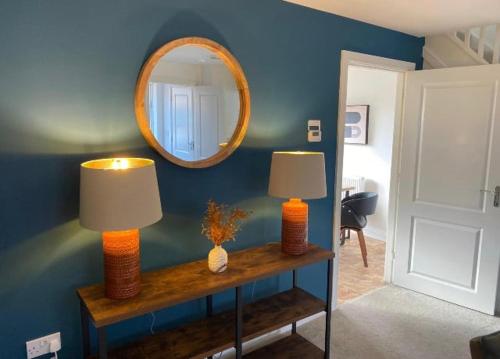a room with two lamps on a table with a mirror at Temper Mill 3 BR Garden & FREE parking in Newport