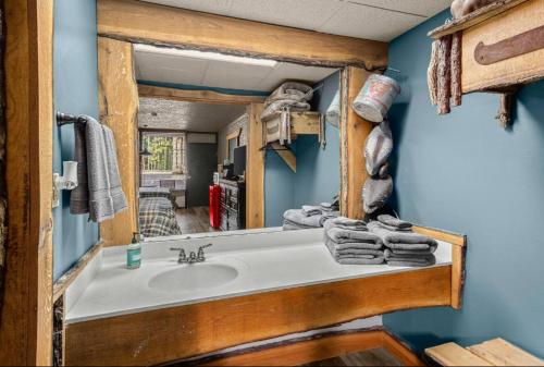 a bathroom with a sink and a mirror at Stonegate Lodge W Pool & Outdoor Firepits Room #201 in Eureka Springs