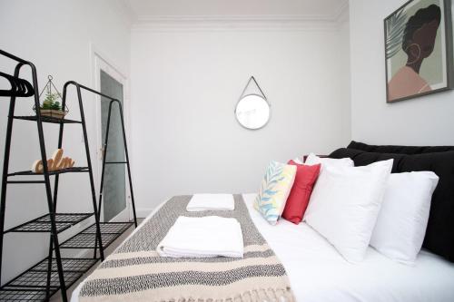 a white living room with a couch and pillows at Garden | Parking | 4BR in Newport