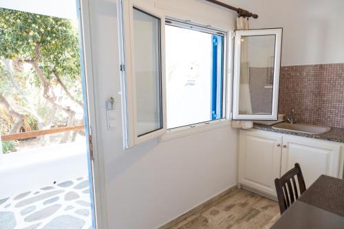 a kitchen with a window and a sink at VILLA VASILIS ORNOS in Mikonos