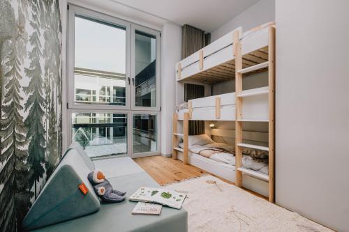 a bedroom with bunk beds and a window at TheChipp - Designapartment mit Seeblick, Pool, Sauna & Kamin in Bad Saarow
