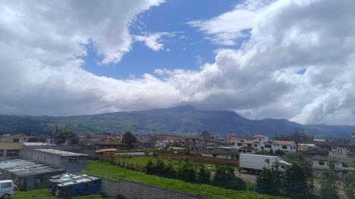 vistas a una ciudad con una montaña en el fondo en LULU HOUSE, en Machachi