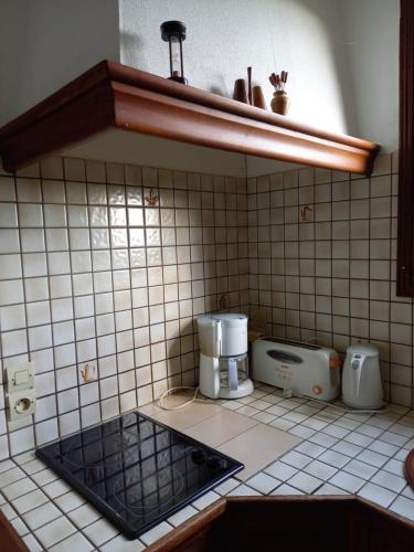 a kitchen with a coffee maker on a tiled counter at la maisonnette du peu-morier in Vouvray