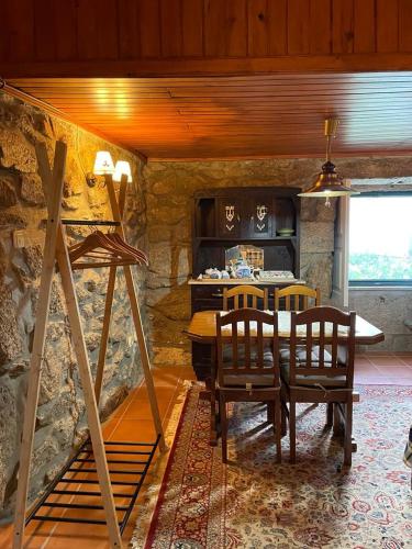 a kitchen with a table and chairs in a room at Casa dos Limões in Arcos de Valdevez