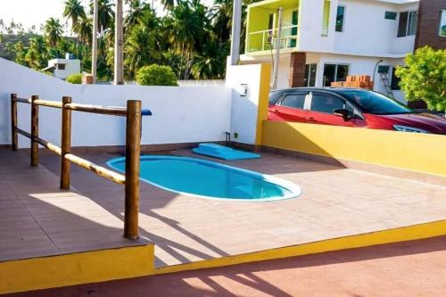 a small swimming pool in a yard next to a house at Lady Sea Praia do Patacho in Pôrto de Pedras