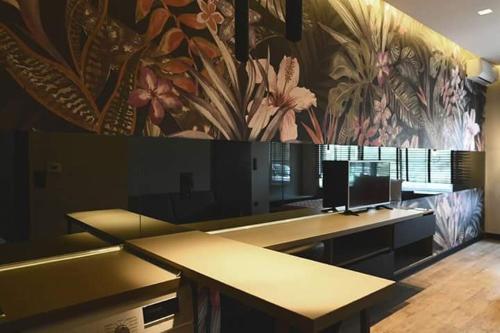 a row of desks in a room with flowers on the wall at Avenue Luxury Apartments in Alexandroupoli