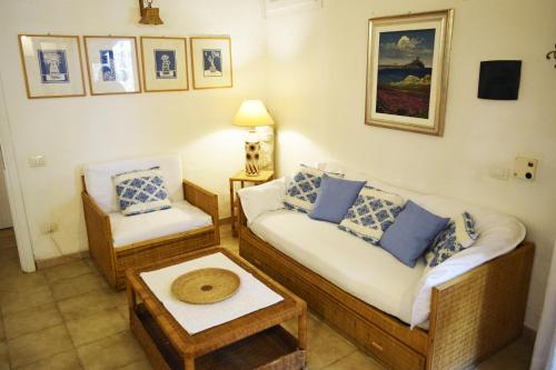a living room with two couches and a table at Casa Agostina in Pula