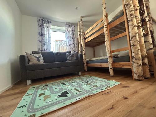 a living room with two bunk beds and a rug at Ferienwohnung im Usseltal - Monheimer Alb - Altmühltal - Familie Geyer - Daiting in Monheim