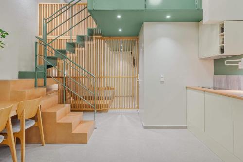 a spiral staircase in a room with a table and chairs at Mystique Loft Ioannina in Ioannina