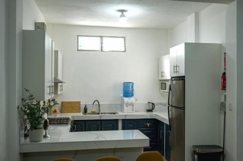 a kitchen with a sink and a refrigerator at Casa Valencia 6 in Santa Elena