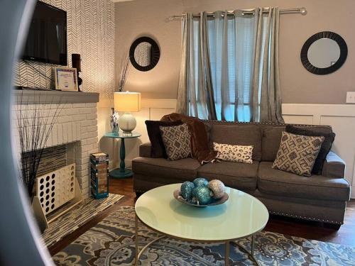 a living room with a couch and a table at Cozy Home in the Heart of Jackson/UMMC Hospital in Jackson