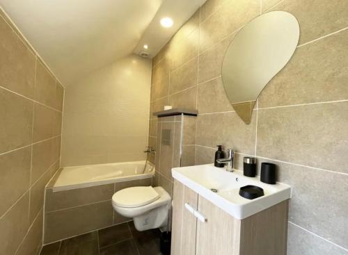ein Badezimmer mit einem Waschbecken, einem WC und einer Badewanne in der Unterkunft The Kiki's Home in Chartres