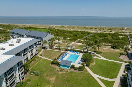 an aerial view of a resort with a pool and the ocean at Harbor Island F206 in Oceanmarsh Subdivision