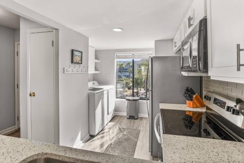 a kitchen with white cabinets and a sink at Harbor Island F206 in Oceanmarsh Subdivision