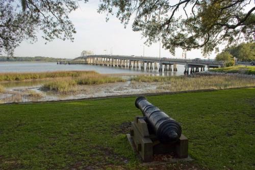 a cannon in a park with a bridge in the background at Harbor Island F206 in Oceanmarsh Subdivision