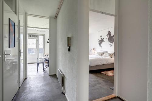 a bedroom with a bed and a hallway with a mirror at Apartment Hotel Zuid Oost Heesterveld BnB ZOH in Amsterdam