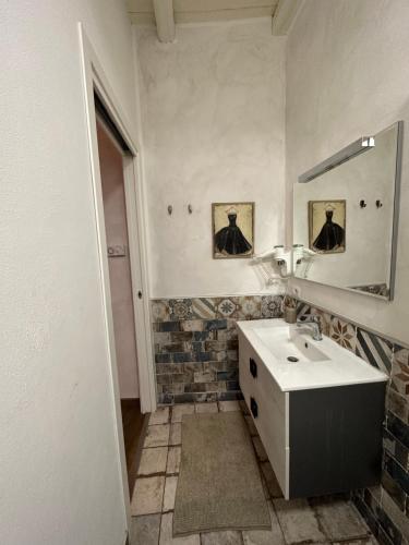 a bathroom with a sink and a mirror at DOMUS TUSCIA APARTMENTS Via Estrema 2 in Viterbo