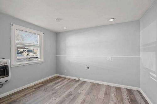 an empty room with white walls and a window at Charming retro property! in Sparks