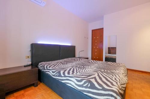 un letto in una camera con stampa zebra di Intero alloggio: appartamento a Bergamo