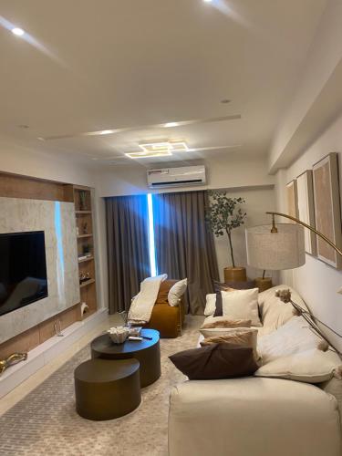 a living room with a couch and a tv at Solaris in Accra