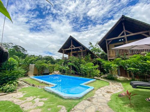 a swimming pool in the yard of a house at Canto del Río Lodge in Tarapoto