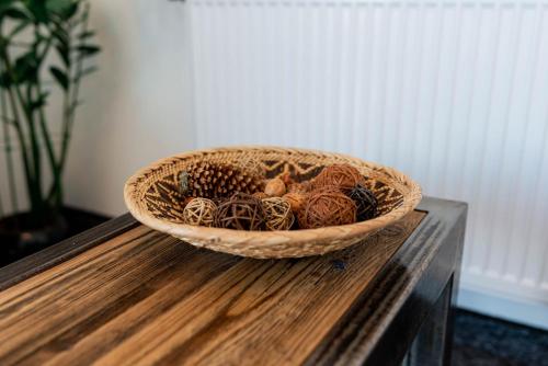 a basket filled with pine cones sitting on a table at Pokoje Na Winklu in Kluszkowce