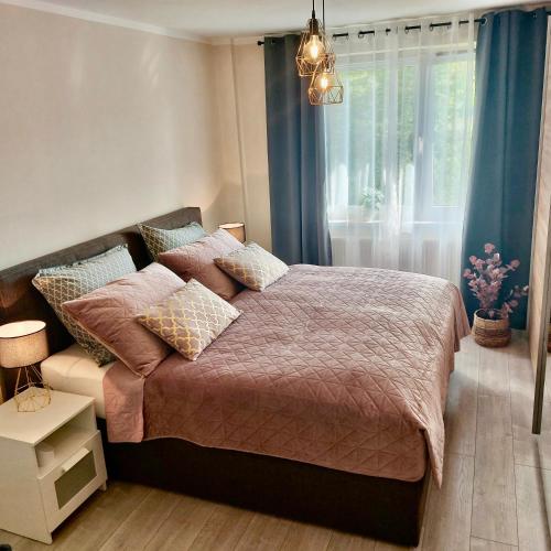 a bedroom with a large bed and a window at Apartment am Hochwald in Reinhardtsdorf