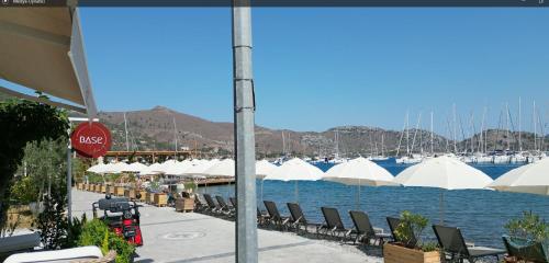 a group of chairs and umbrellas next to the water at Base Selimiye in Marmaris