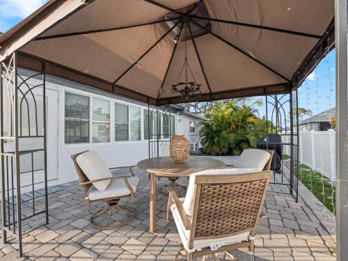 a patio with a table and chairs and an umbrella at Your Paradise in Venice - Near Beaches in Venice