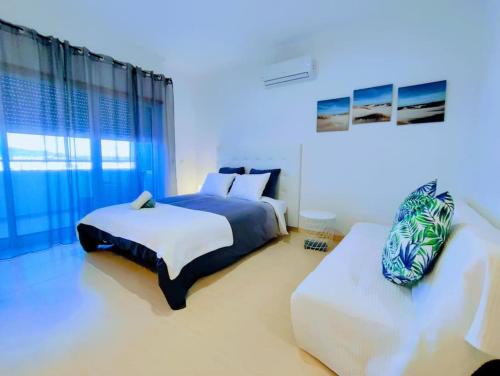 a bedroom with two beds and a large window at Mountain View Club Faia in Portimão