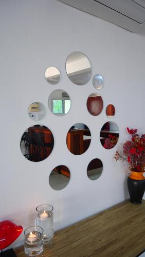 a wall with round mirrors on a white wall at Résidence Tropicale in Libreville
