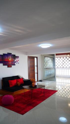 a living room with a couch and a table at Résidence Tropicale in Libreville