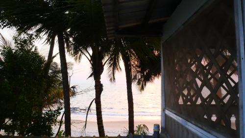 a view of the beach from a house with palm trees at Résidence Tropicale in Libreville