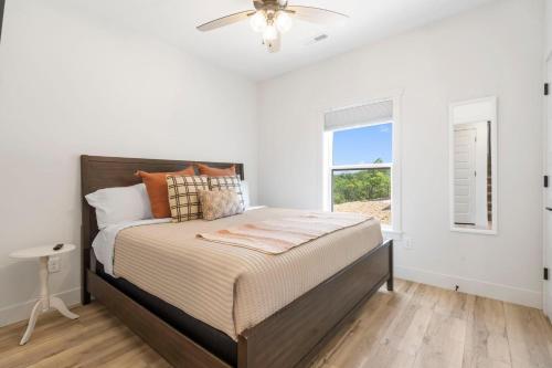 a white bedroom with a bed and a window at Legacy Lakeside Retreat in Kimberling City
