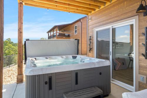 a hot tub on the deck of a house at Legacy Lakeside Retreat in Kimberling City