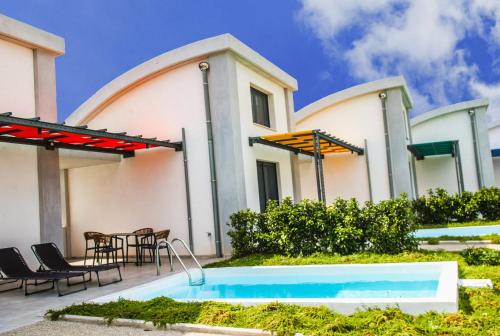a villa with a swimming pool and a patio at Aurora Suites in Nea Fokea