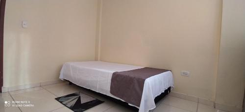 a corner of a room with a bed in a room at 2112 in Pereira