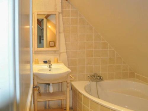 a bathroom with a sink and a bath tub at le Clos in Chambourg-sur-Indre