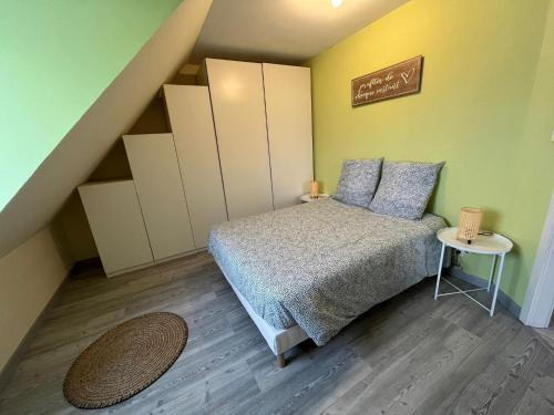 a small bedroom with a bed and a staircase at Sérénité alsacienne in Seltz