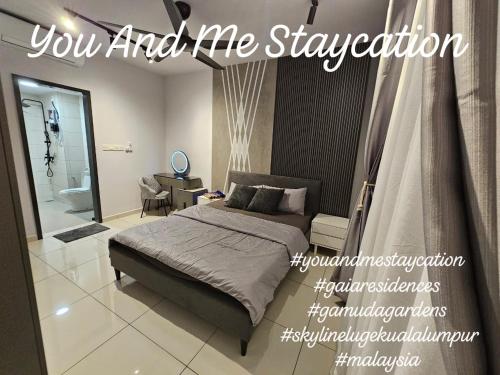 a bedroom with a king sized bed and a bathroom at You And Me Staycation in Rawang