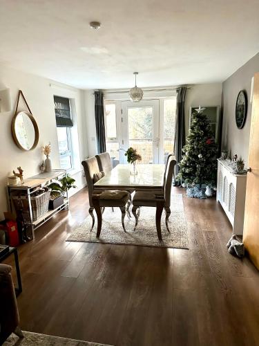 a living room with a table and a christmas tree at Escape Homestay 