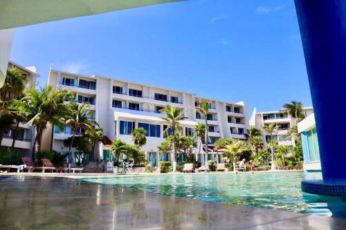 a swimming pool in front of a hotel at Preciosas vista al mar, a 10 min. del aeropuerto -Sol2401- in Cancún