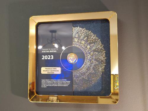 a gold box with a medal on a wall at Pinewood ANG premium luxurious apartment 15 in Borovets