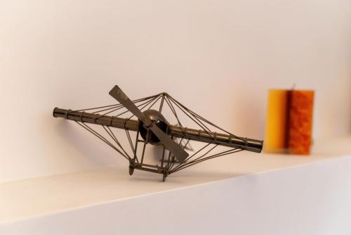 a model of a biplane on a shelf next to a book at Port house with amazing sea view and jacuzzi in Ierápetra